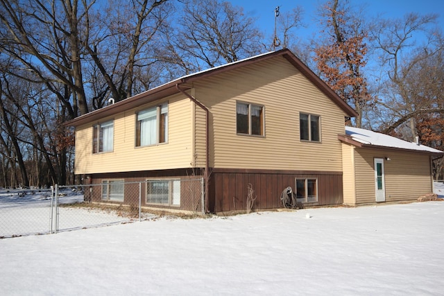 view of snow covered back of property