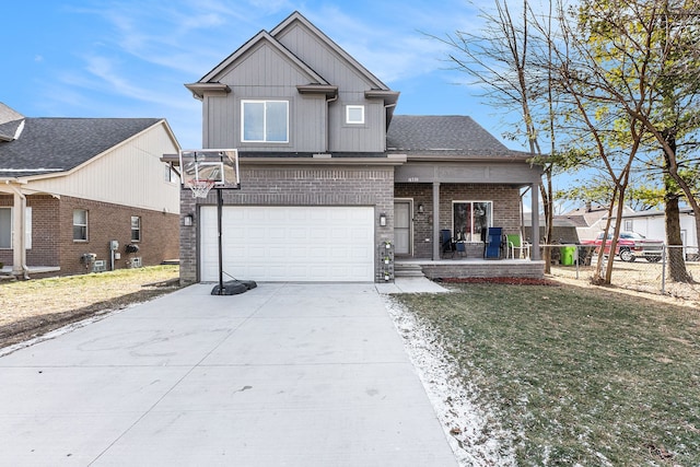 view of front of house with a front yard, a garage, and covered porch