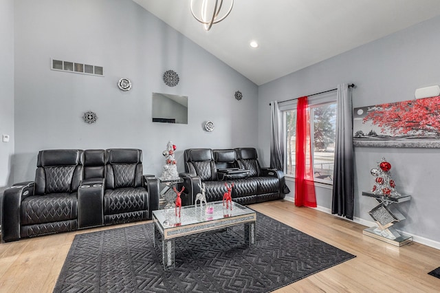 living room with hardwood / wood-style flooring and high vaulted ceiling