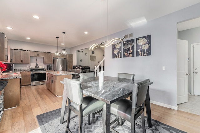 dining space featuring light hardwood / wood-style floors