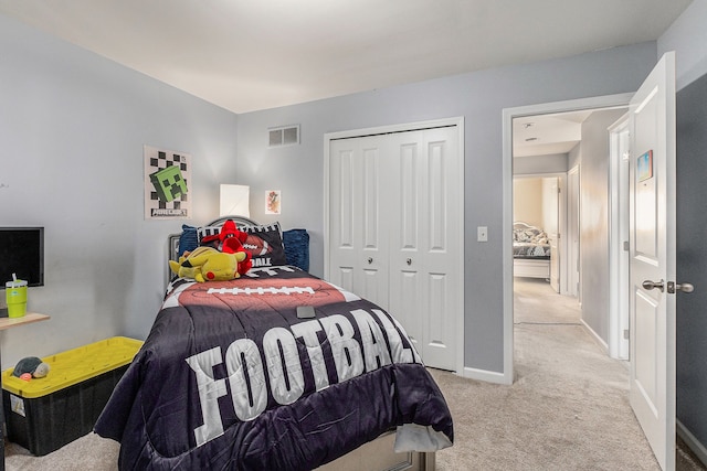 bedroom featuring a closet and light carpet