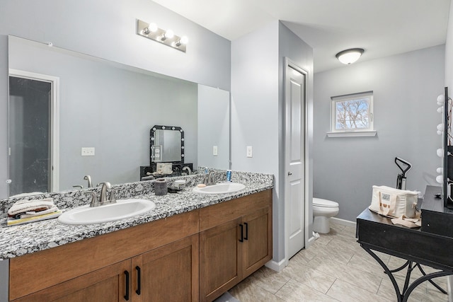 bathroom featuring toilet and vanity