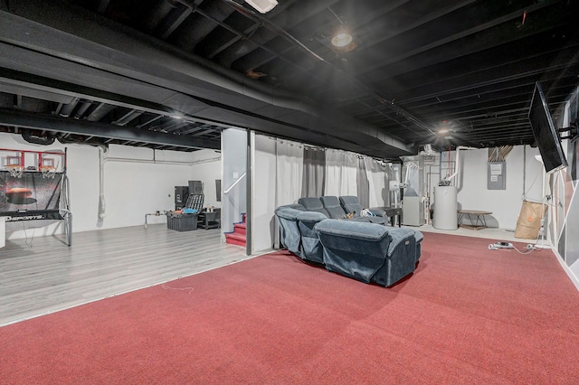 basement featuring water heater, carpet, and electric panel