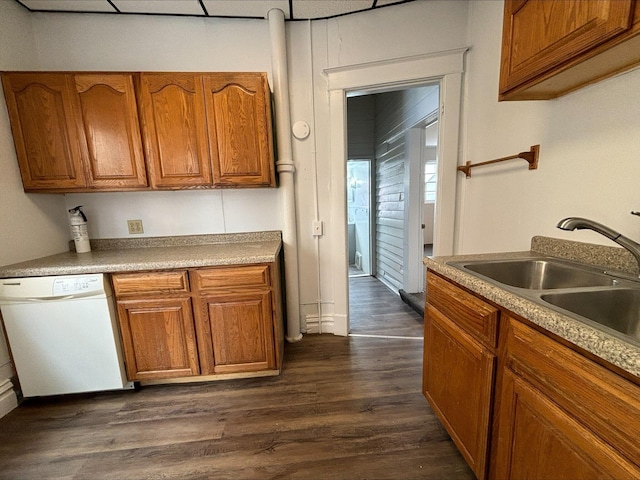 kitchen with white dishwasher, dark hardwood / wood-style floors, and sink