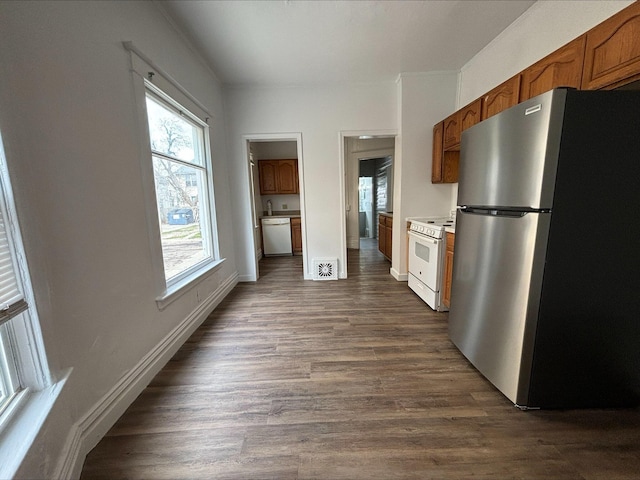 kitchen with white appliances and dark wood-type flooring