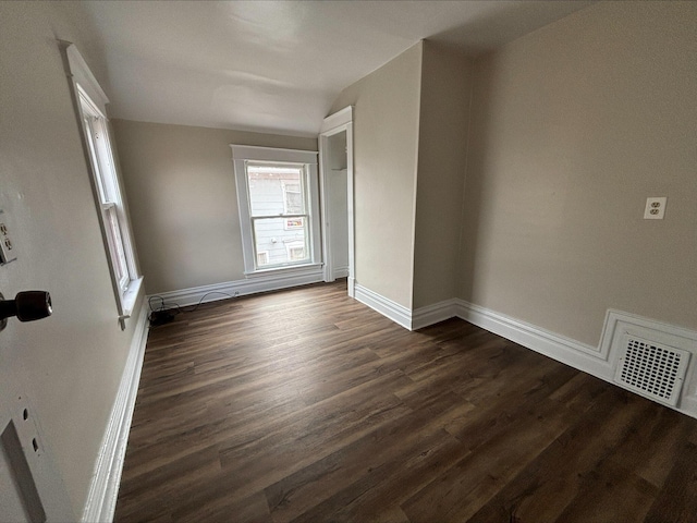 unfurnished room featuring dark wood-type flooring