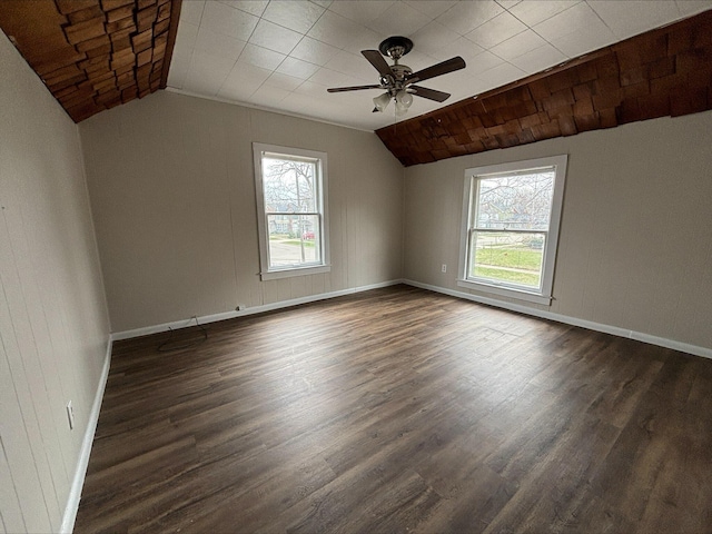 unfurnished room featuring dark hardwood / wood-style floors, ceiling fan, and vaulted ceiling