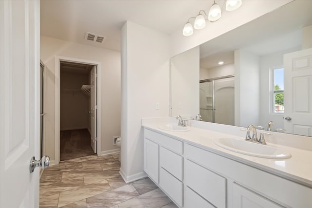 bathroom with vanity, toilet, and walk in shower