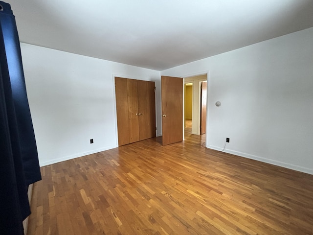 unfurnished room with wood-type flooring