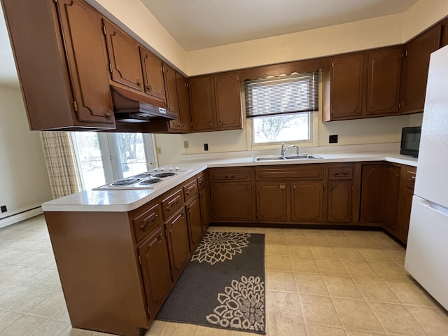 kitchen featuring sink, white appliances, and kitchen peninsula