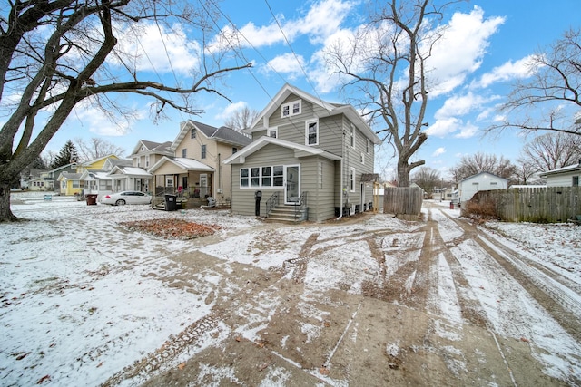 view of snow covered rear of property