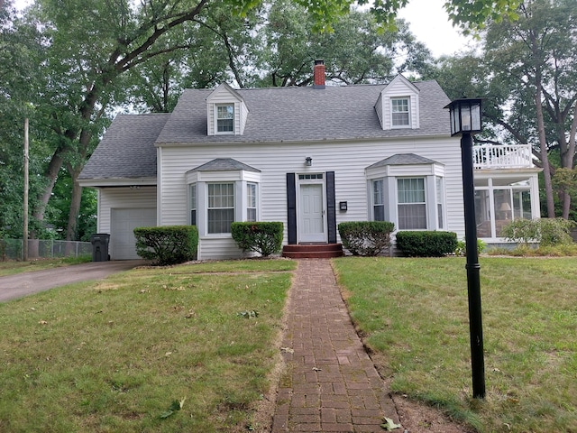 new england style home with a front lawn and a garage