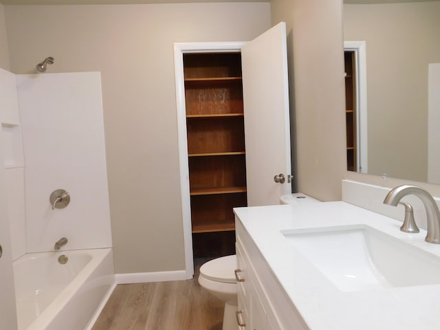 full bathroom with toilet, wood-type flooring, vanity, and bathing tub / shower combination