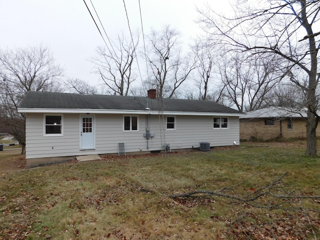 back of property featuring a lawn