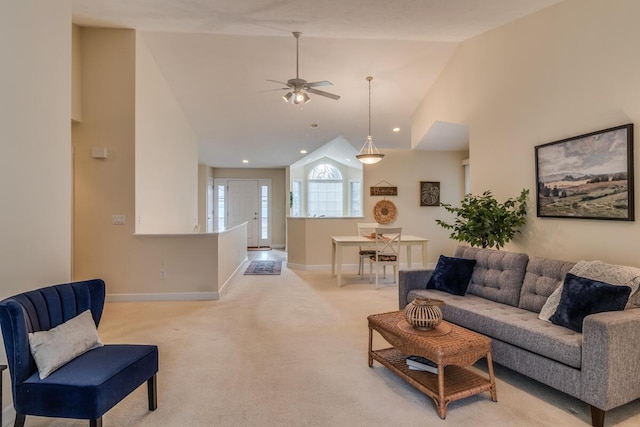 living area with a ceiling fan, baseboards, high vaulted ceiling, recessed lighting, and light colored carpet