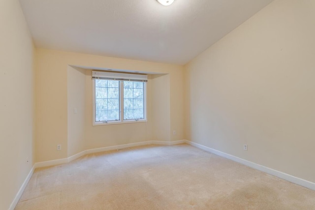 empty room with light carpet and baseboards