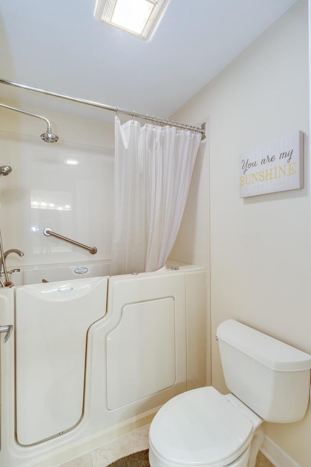 full bathroom featuring tile patterned flooring, toilet, and a shower with shower curtain