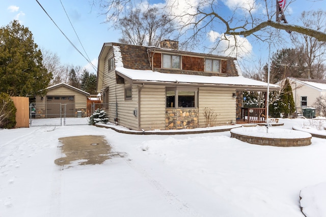 view of front of property with a garage and an outdoor structure