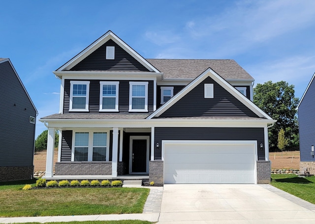 craftsman-style house with a garage and a front lawn