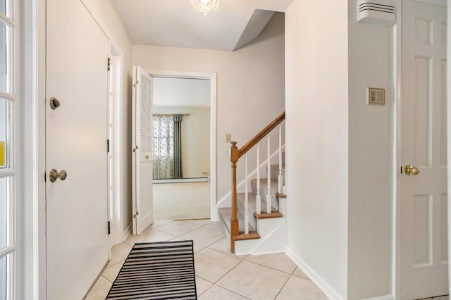 foyer entrance featuring light tile patterned floors and a baseboard heating unit