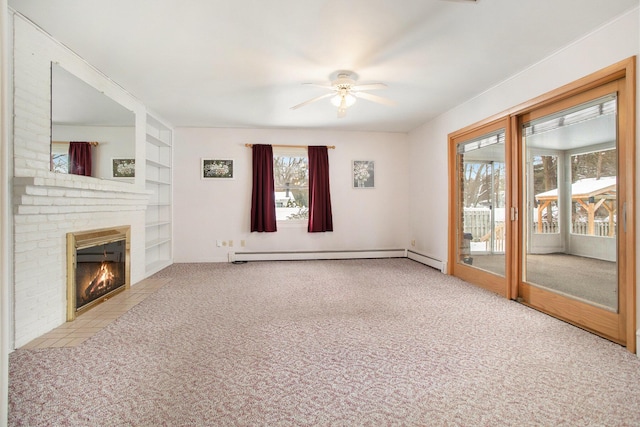 unfurnished living room with light carpet, a brick fireplace, built in shelves, ceiling fan, and a baseboard heating unit