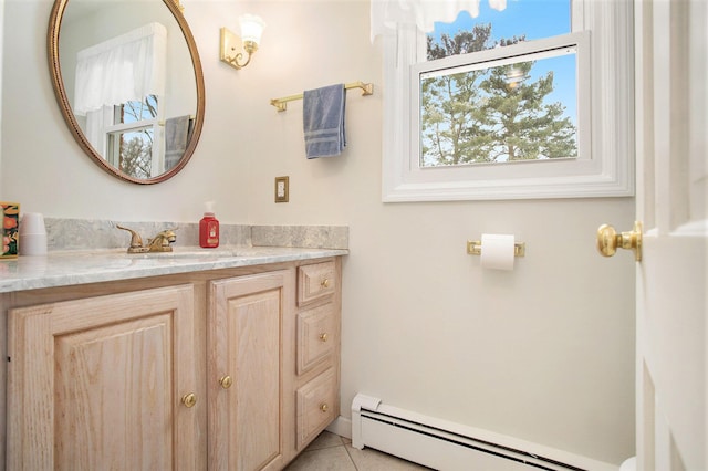 bathroom featuring tile patterned flooring, vanity, and a baseboard heating unit