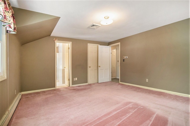 unfurnished bedroom featuring carpet flooring, vaulted ceiling, ensuite bath, and baseboard heating