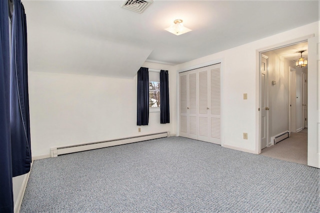 unfurnished bedroom featuring a closet, light colored carpet, a baseboard radiator, and lofted ceiling