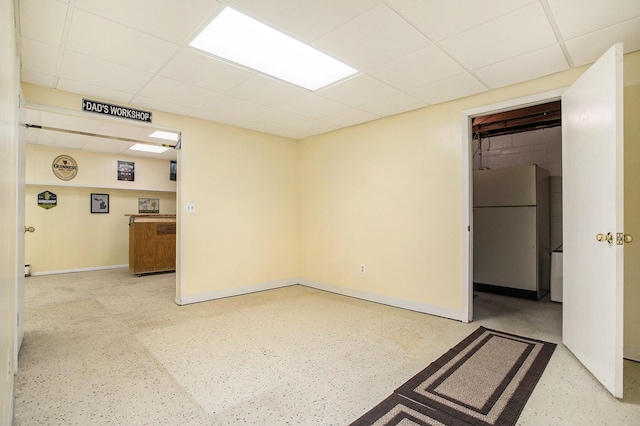 unfurnished room with a drop ceiling