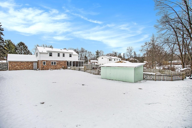 yard covered in snow featuring an outbuilding