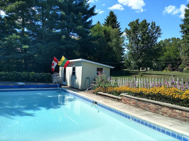 view of pool with an outdoor structure