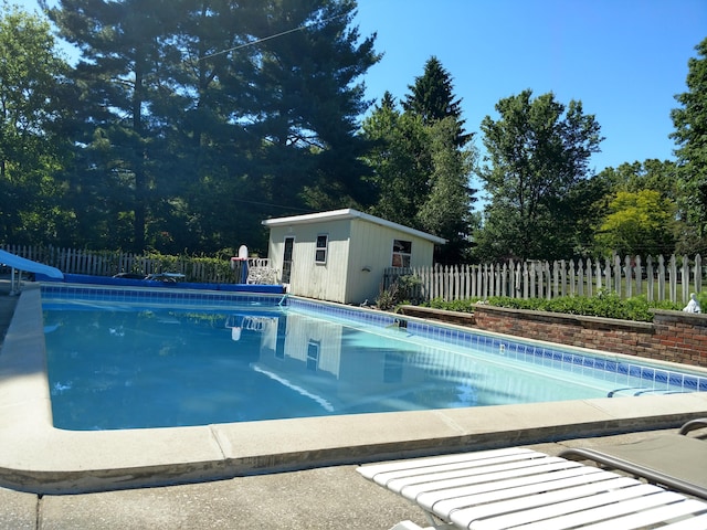 view of pool featuring an outdoor structure and a water slide