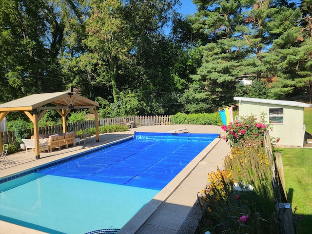 view of pool with a gazebo, a patio, and an outdoor structure