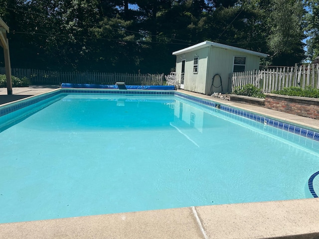 view of swimming pool with an outdoor structure