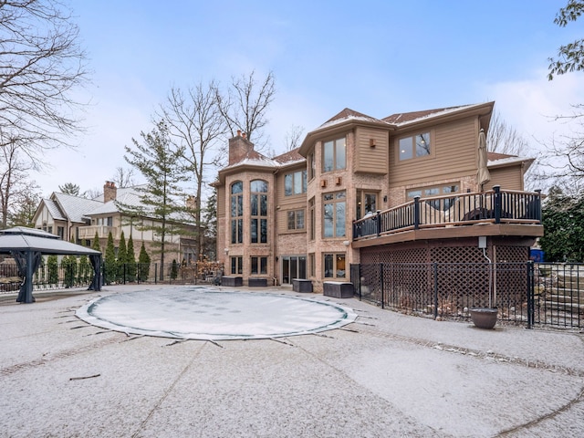 rear view of property with a gazebo and cooling unit