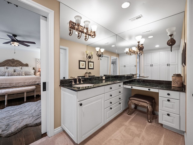 bathroom with ceiling fan and vanity