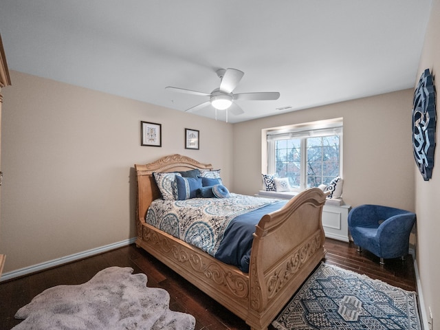 bedroom with ceiling fan and dark wood-type flooring