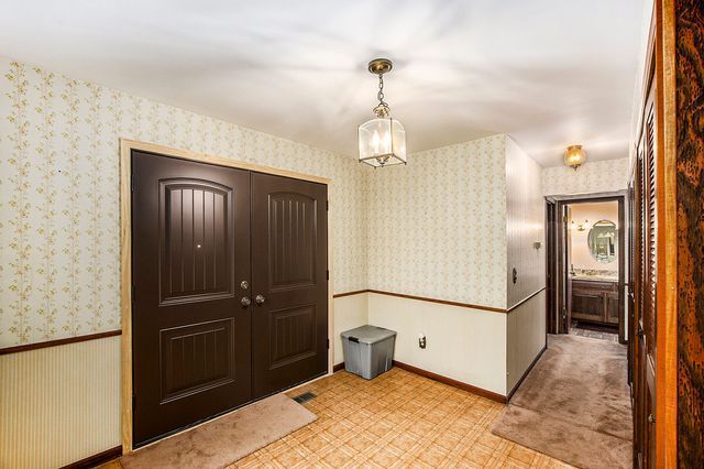 foyer entrance with an inviting chandelier