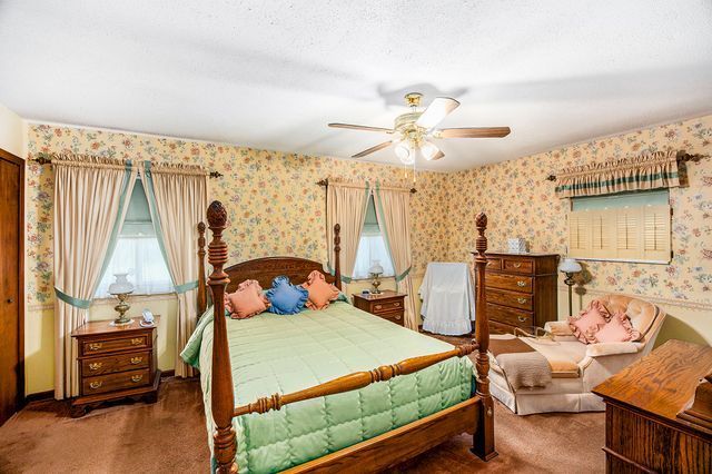 carpeted bedroom featuring ceiling fan