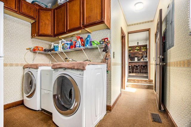 washroom with light colored carpet and washing machine and dryer