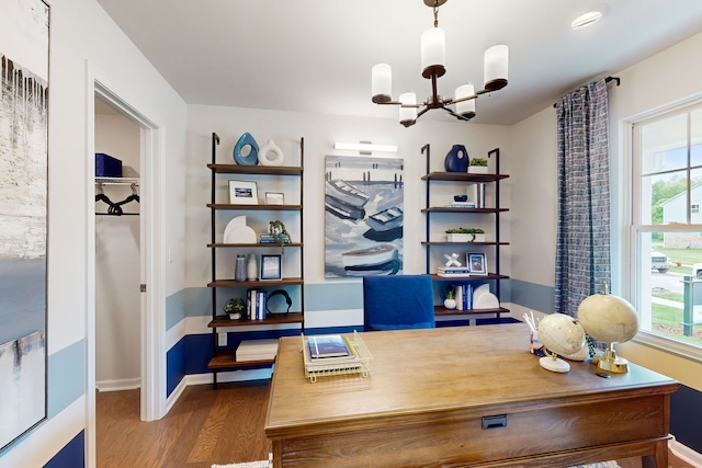 office area with baseboards, a notable chandelier, and wood finished floors