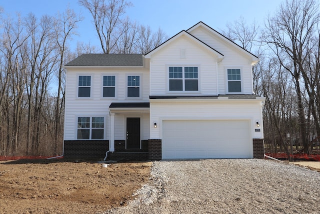 view of front of property with a garage, brick siding, and dirt driveway