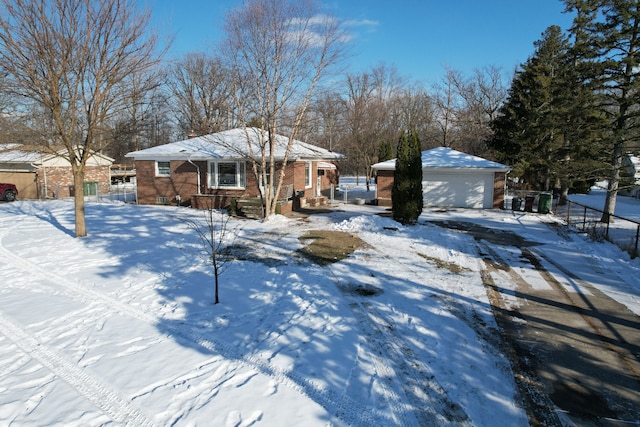 view of front of house with a garage and an outbuilding