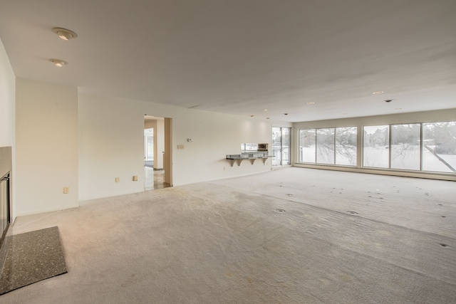 unfurnished living room featuring light colored carpet