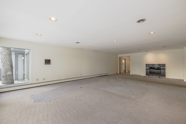 unfurnished living room featuring carpet flooring, a fireplace, and a baseboard radiator