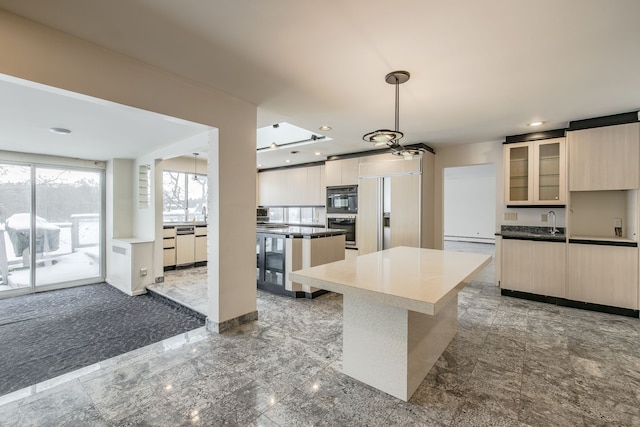 kitchen with a center island, sink, paneled built in fridge, pendant lighting, and dishwashing machine