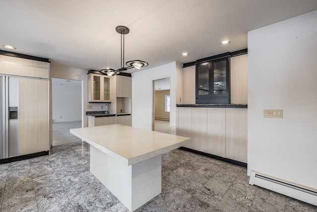 kitchen with a chandelier, a center island, hanging light fixtures, and a baseboard radiator