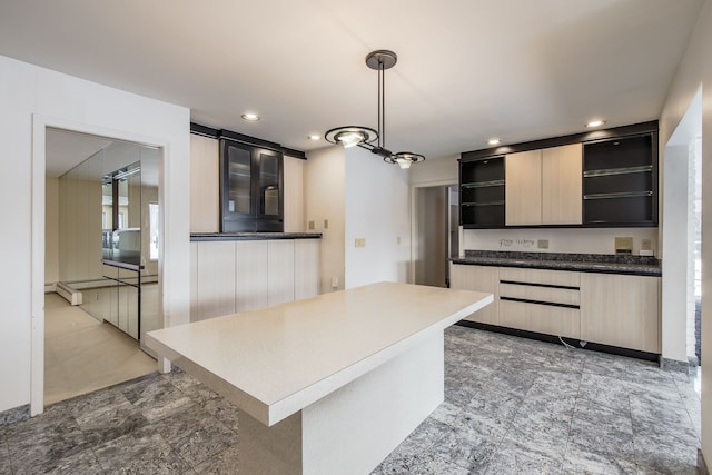 kitchen with decorative light fixtures, light brown cabinets, and a chandelier