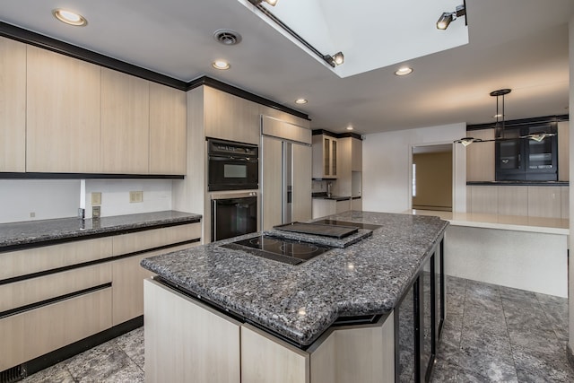 kitchen with pendant lighting, a center island, light brown cabinets, black appliances, and a kitchen bar