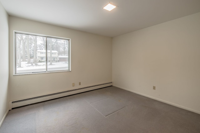 carpeted spare room featuring a baseboard radiator